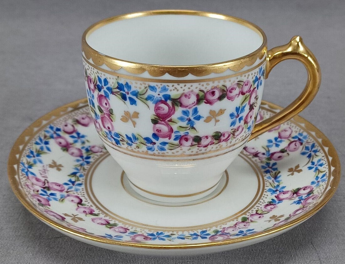 Pickard Hand Painted Demitasse Cup & Saucer: Nice antique porcelain demitasse cup and saucer. Decorated with hand painted pink roses, blue flowers, and gold leaves and dots. Scalloped gold gilding along the edge. Marked on the bottom GDA France 