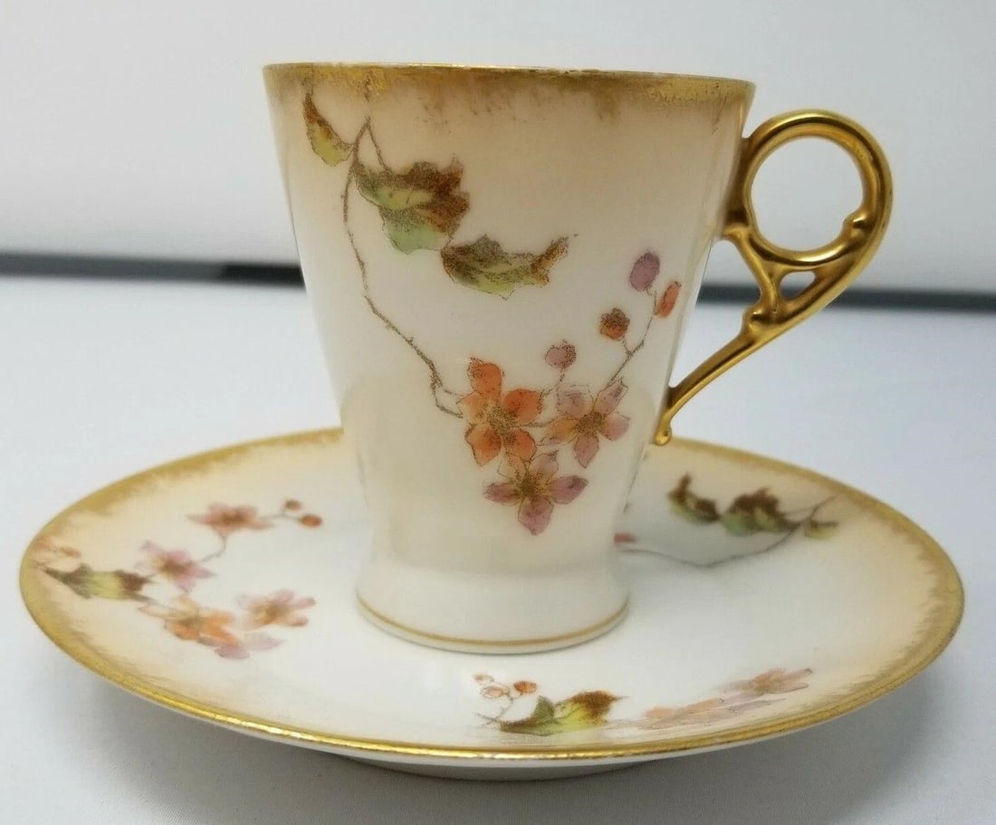 Haviland Limoges GDM - Hand Decorated Cup & Saucer: CH Field Haviland Limoges GDM teacup & saucer. Decorated with flowers and leaves, the coloration is reminiscent of Royal Worcester blush ivory. The cup stands 2 1/2 inches tall and the saucer is 4