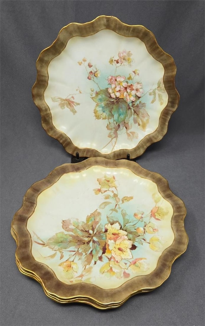 Set 4 Doulton Burslem Aesthetic Style Plates: Doulton Burslem set of 4 plates with flowers in Aesthetic style. Circa 1886 to 1891. Hand painted flowers with gold accents with a brown and green rim bordered by gold gilt. Very nice condition