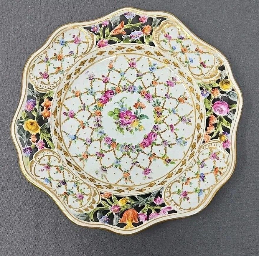 Carl Thieme Pottschappel Reticulated Plate: Carl Thieme Pottschappel reticulated plate in a Dresden floral style pattern. Intricately painted flowers design. Measures approximately 1 1/8 inches tall and 8 3/4 inches diameter. No chips or cracks