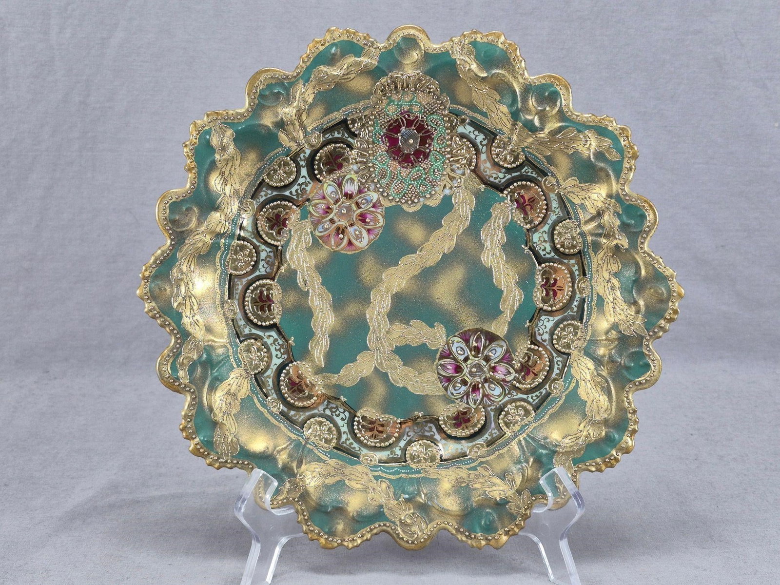 Nippon Green & Blue Raised Gold Beaded Plate: Antique Japanese porcelain plate. Decorated with gold, puce, and blue floral medallions, and gold and crimson medallions with gold beading and raised gold leaves over a green and sponged / clouded gol