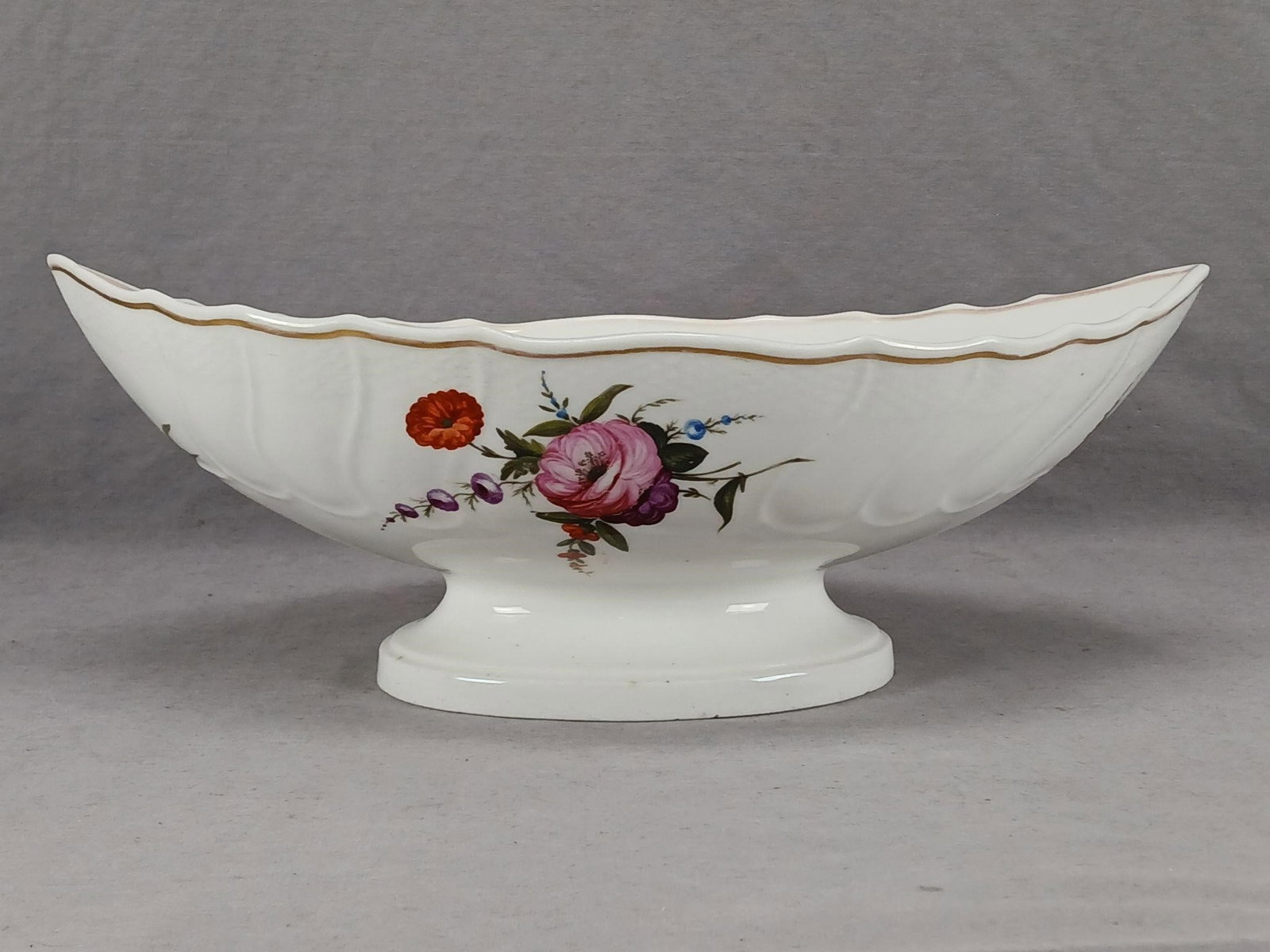 Coalport Hand Painted Centerpiece Bowl C.1800-1810: Nice British porcelain centerpiece with basketweave molded border. Decorated with hand painted flowers in pink, yellow, blue, purple, and red. Gold gilding along the edge. Unmarked. Made by Coalport. 
