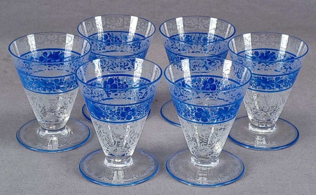 6 Bohemian Engraved Floral & Blue Enamel Cordials: Set of 6 early 20th century Bohemian footed cordial glasses with engraved floral scrollwork. Has a hand enameled blue floral band and blue trim along the rim and foot rim. Unsigned.Good condition.Each