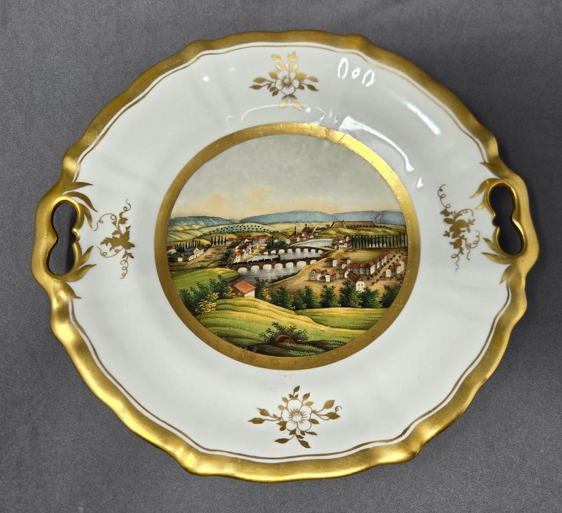 Schumann Hand Painted Landscape Scene Dessert Tray: Friedrich Adolph Schumann handled dessert tray, serving plate. Hand painted landscape with a town on a river with mountains in the background and a train crossing over a bridge. Made in a factory in M