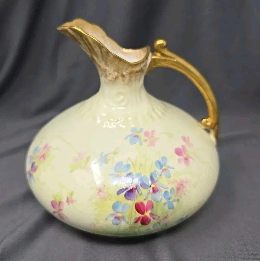 Pointons Stoke on Trent English Vase: Pointons Stoke on Trent blush ivory vase or small pitcher. Hand painted with wild flower design. Molded design on top and handle. Circa 1891 to 1916. Measures 4 3/4 inches tall and 5 inches wide.We ca