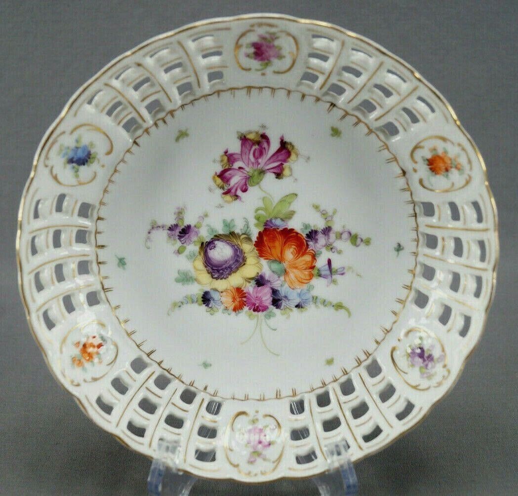 Wolfsohn Dresden Hand Painted Reticulated Bowl: Pretty porcelain reticulated shallow bowl. Decorated with hand painted flowers in pink, purple, yellow, blue and orange. With gold gilt highlights to the reticulation and small flowers framed in gold 