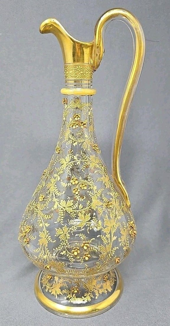 Bohemian Moser Style Gilt Glass Wine Ewer: Bohemian Moser style wine ewer / claret jug. Raised gold and enamel flowers. With an applied handle, and applied glass ring around neck. There is no stopper but no indication there was ever one, which