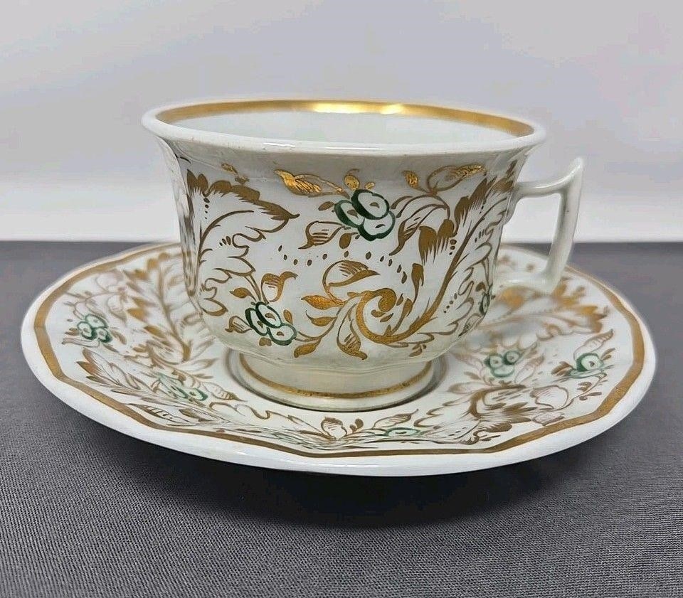 Old Paris Green & Gold Tea Cup & Saucer: Old Paris Porcelain tea cup and saucer set. Green and gold flowers and leaves with gold rimmed edges. Circa 1850s. Very good condition without chips or cracks. Some stains in the cup as shownMinor los