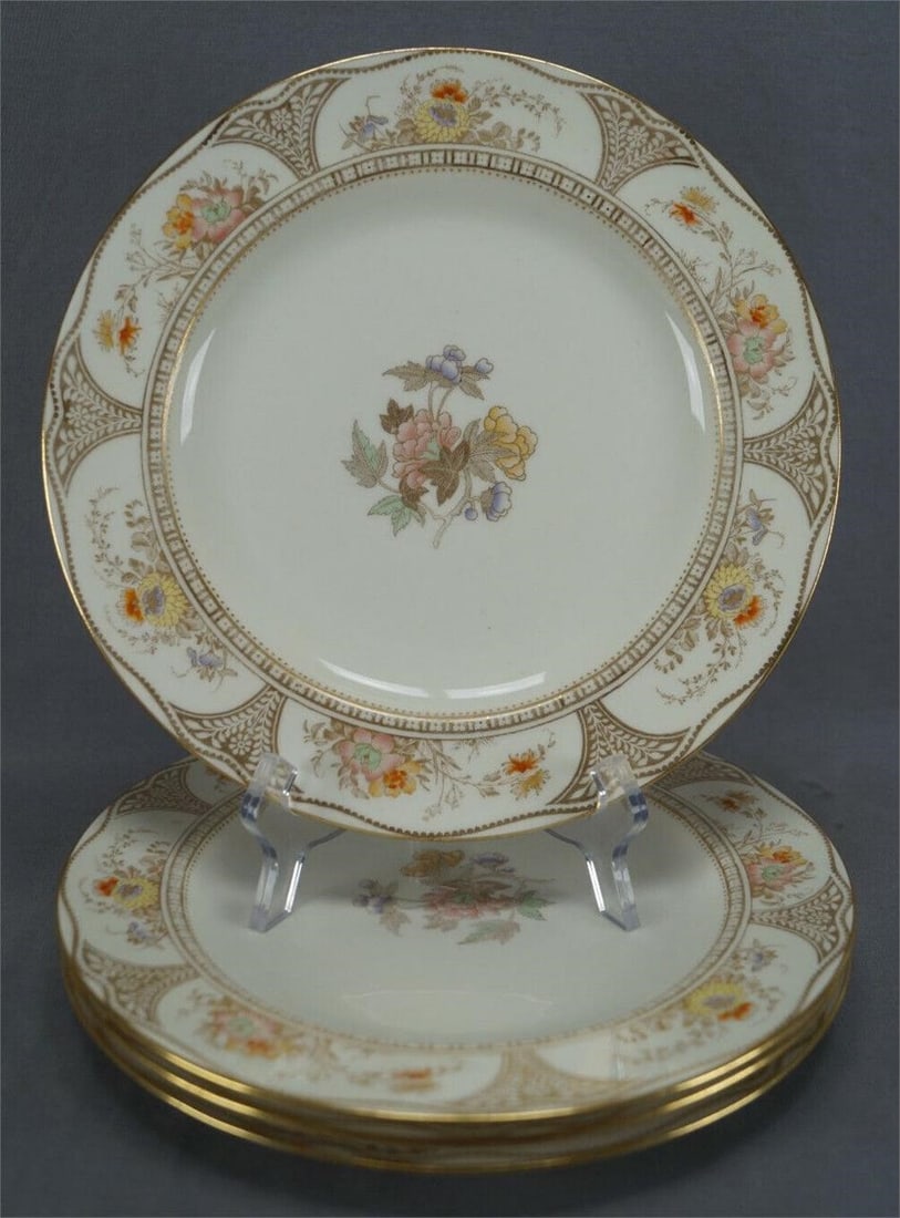 4 Wedgwood Hand Colored Floral & Gold 10" Plates: Set of 4 bone china dinner plates. Decorated with transfer flowers with hand coloring in pink, purple, yellow, orange and green. Gold gilt Art Nouveau floral border. Marked on the bottom with the urn 