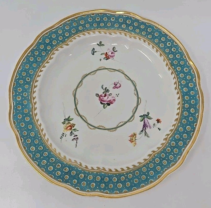 Early Derby Plate Jeweled Turquoise Border: Antique Derby hand painted plate. It has a turquoise blue border with enamel beading. Floral sprays in the center with a gold and blue woven ring. No cracks or crazing. There are scratches from use an