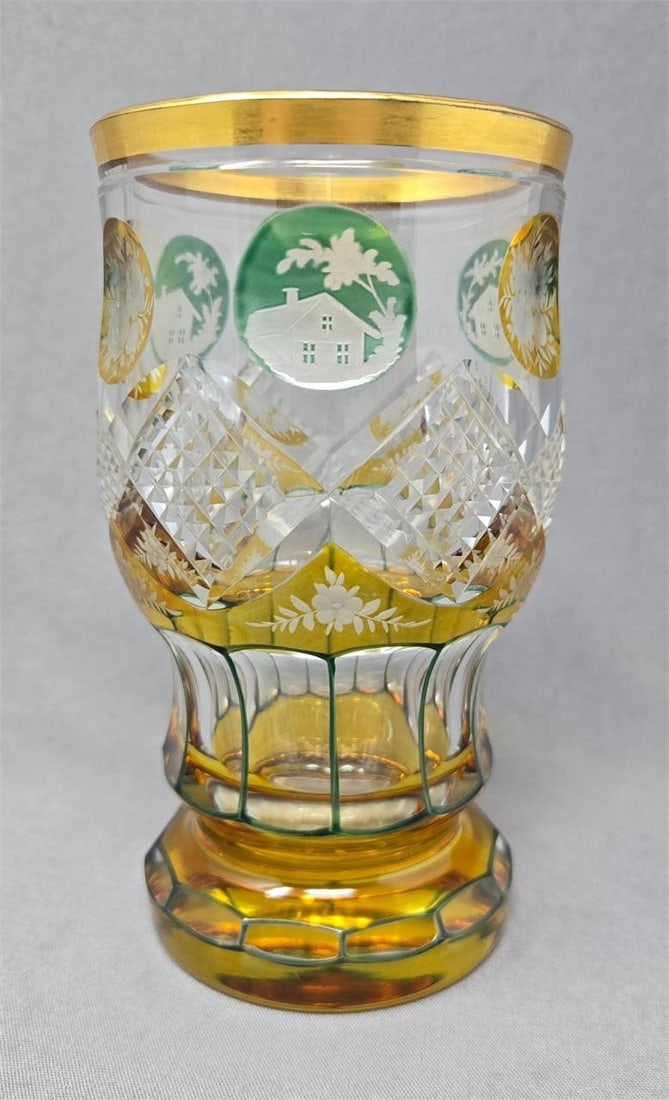 Cut Glass Cup Yellow & Green Etched Panels 1890: Bohemian cut glass with etched panels drinking glass. Yellow and green staining on clear glass. Alternating design of green houses and yellow flower panels above diamond cuts and paneled base. Gold