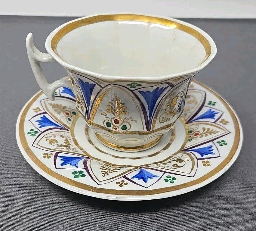 Nathusius Factory Cup and Saucer C. 1850: Nathusius Factory cup and saucer set from 1850s. Made in Germany. Blue, gold, green on white. Approximate measurements: The saucer is 5 3/4 inches in diameter, the cup is 2 1/2 inches tall, and 3 3/ 4