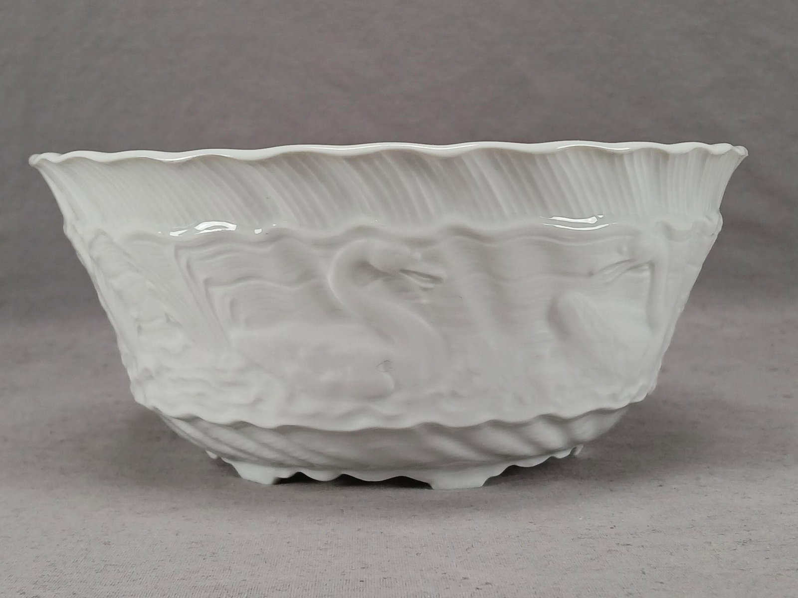 Meissen Swan Service Relief Molded 7 3/8 Inch Bowl: Vintage 20th century Meissen white blanc de chine style relief molded Swan Service bowl. Marked on the reverse with the hand painted crossed swords mark used by Meissen. Also has a gold "Made in Germa