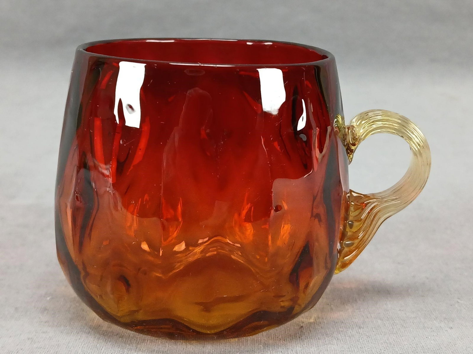 Antique Blocks & Diamond Amberina Punch Cup: Antique Bohemian mold blown amberina glass punch cup. Applied amber reeded glass handle. Has a molded diamond pattern on the inside and molded block pattern on the inside. Ground and polished pontiled
