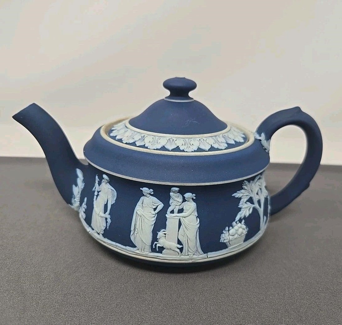 Wedgwood Blue Jasperware Tea Pot St. Louis Form: Wedgwood dark blue jasperware tea pot. Circa 1898. Neoclassical sacrifice figures. Some stains on rim and a few marks and in-manufacturing defects as shown. No chips or cracks. Measures approximately 