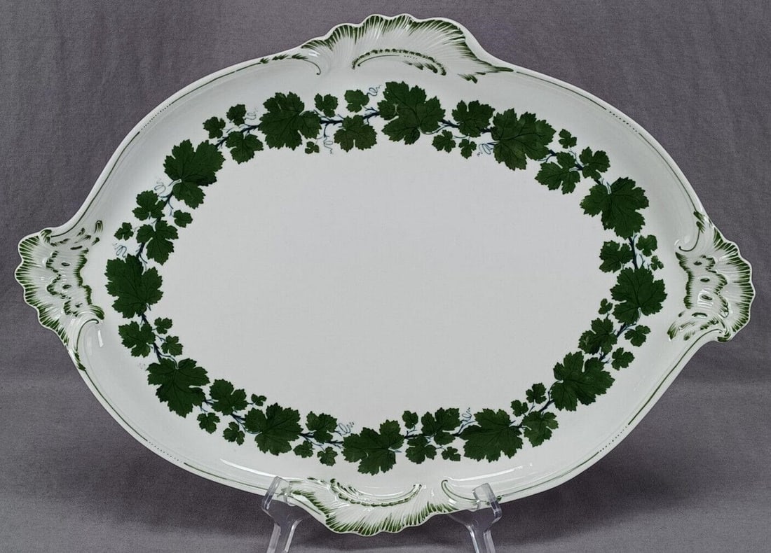 Meissen Green Ivy 18 Inch Tray Circa 1860-1924: Nice antique German porcelain tray with relief molded Rococo scrollwork edge. Decorated in the hand painted Green Ivy pattern. Marked on the bottom with the hand painted underglaze blue crossed swords