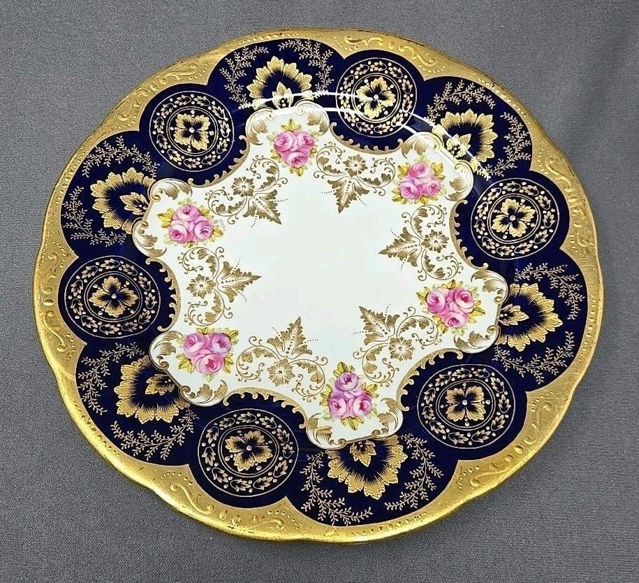 Cauldon Roses, Cobalt & Gold 8 3/4 Inch Plate: Beautiful Cauldon handpainted gold, cobalt blue, and pink roses plate. There is gold gilt on foot rim. There is a crack as shown in the last pictures, There are also light scratches from use. Circa 19