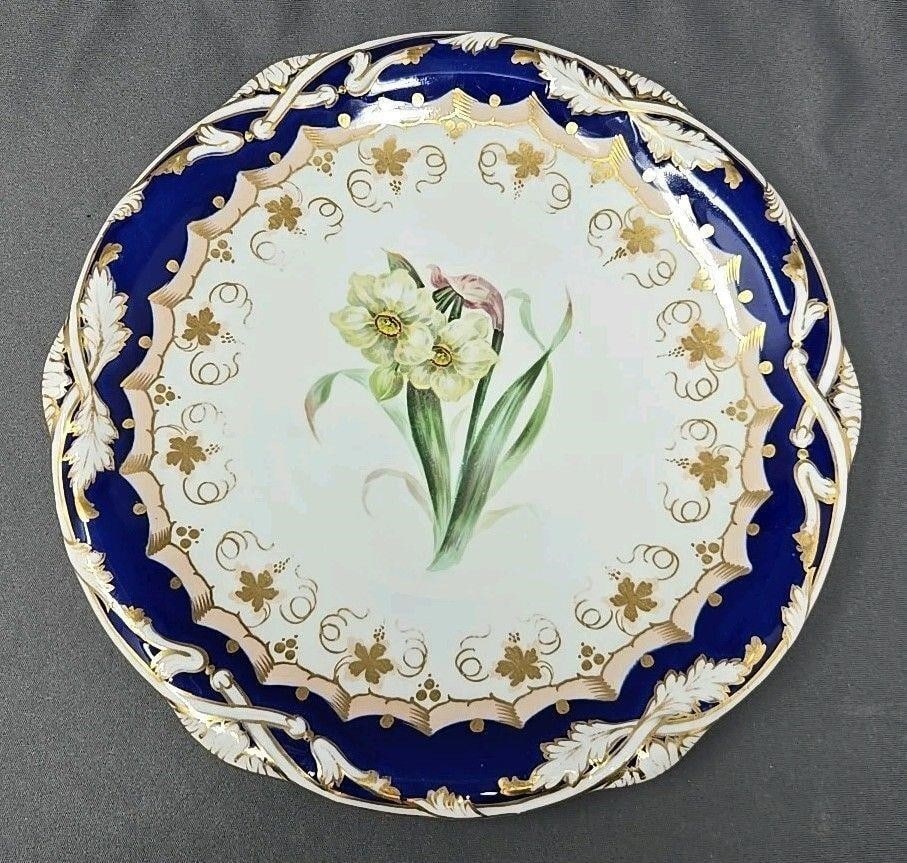 Davenport Narcissus Flower Plate C1815-1830: Davenport plate with a cobalt blue and gold border. Pink decorative band with leaves and grapes and a Narcissus flower in the center. No chips or cracks, some loss of gold on edges. Light scratches fr