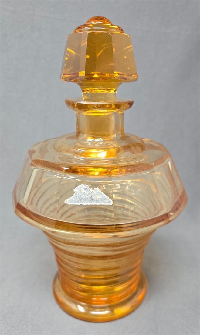 Art Deco Amber Glass Dresser Bottle: Amber glass large dresser bottle / perfume/ cologne with cut and molded design. It has a hard to read label that I believe says Echt Edelkristell. It has some bruises and a chip on underside of