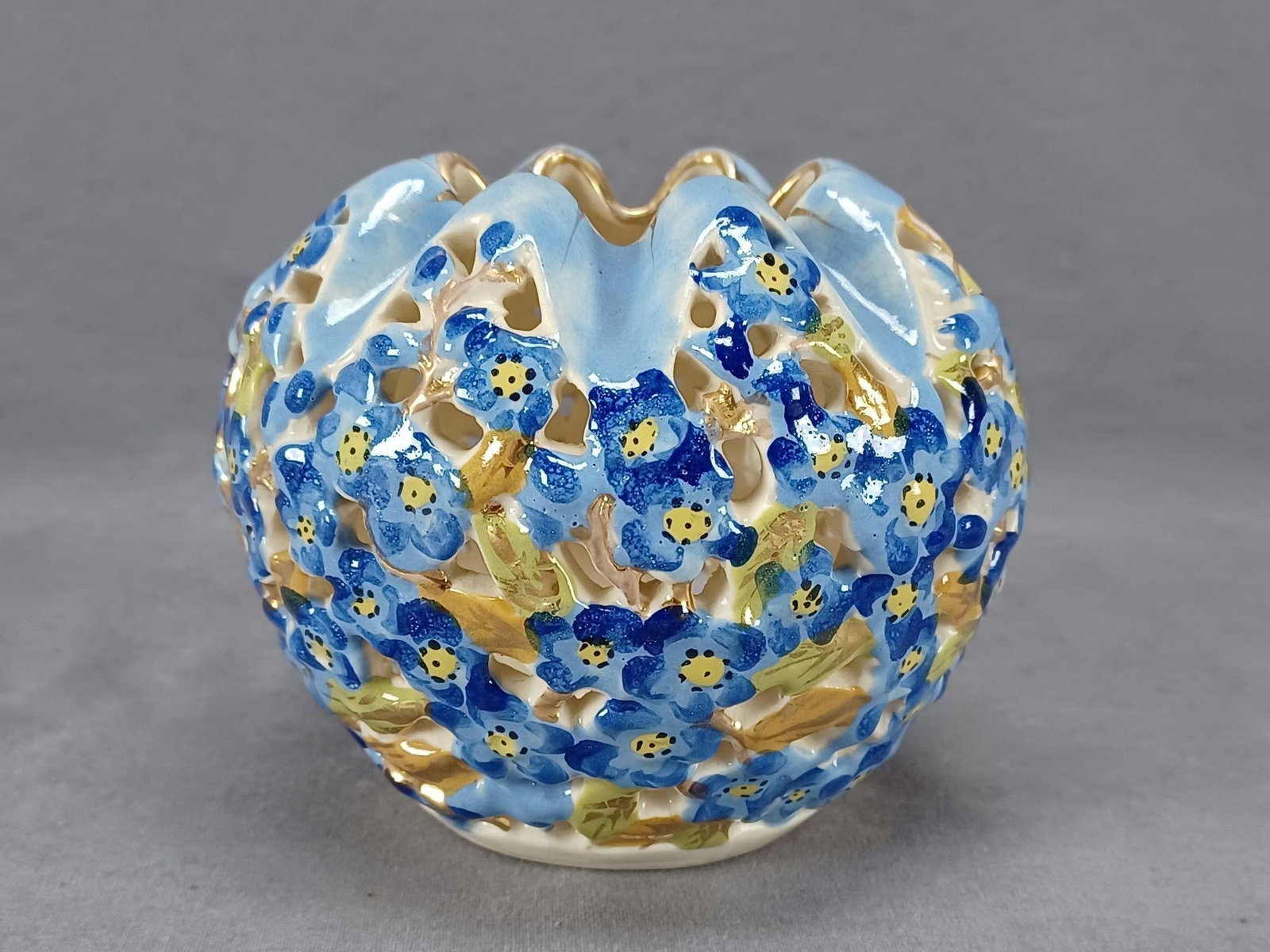 Fischer J Budapest Blue Reticulated Rose Bowl Vase: Nice antique faience pottery reticulated forget me not rose bowl / vase. The flowers are hand painted blue with green and gold leaves. Also painted in blue along the top. With gold gilding along the r