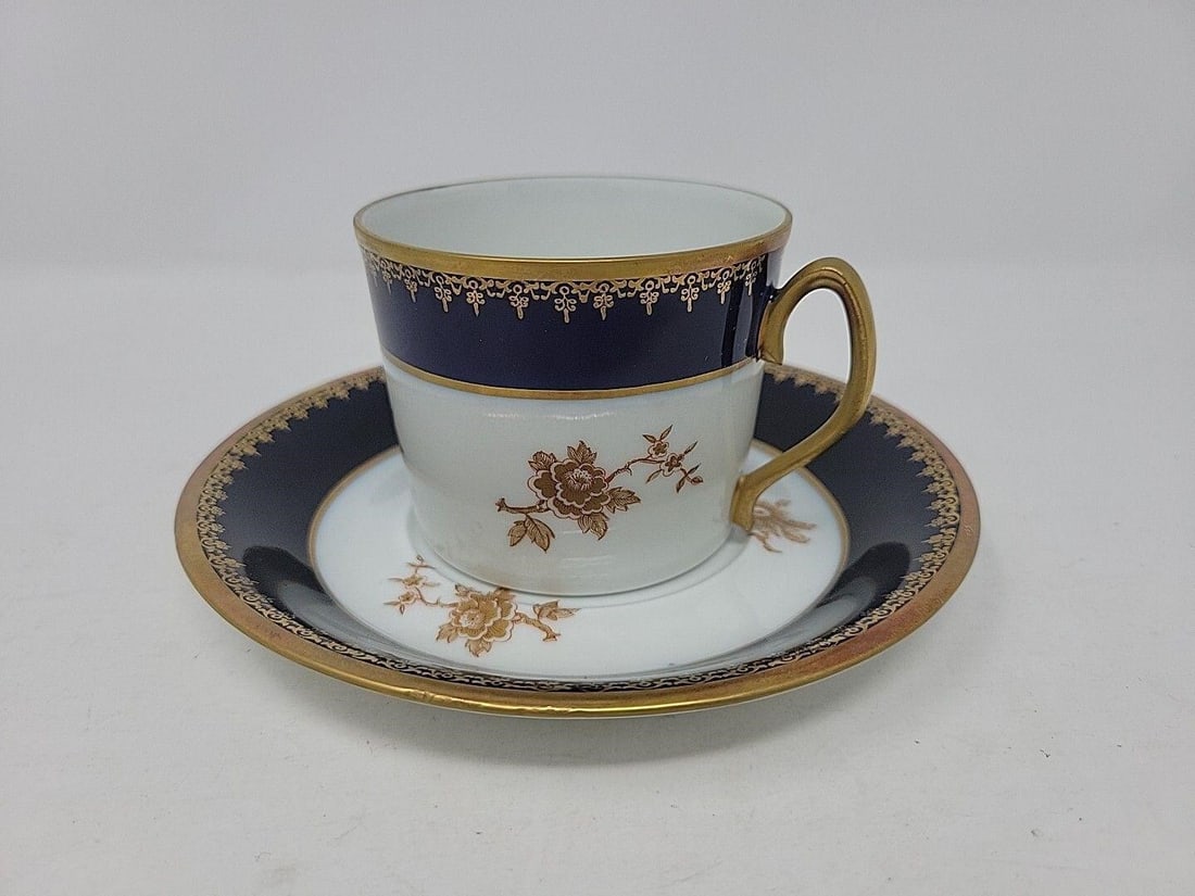 Limoges Tharaud Coffee Can & Saucer Bruxelles: Lovely unused Camille Tharaud Limoges cobalt blue and gold on white coffee Canandaigua saucer. Gold has some slight discoloration from age, otherwise no damage. Measures approximately: saucer5 5/8 inc