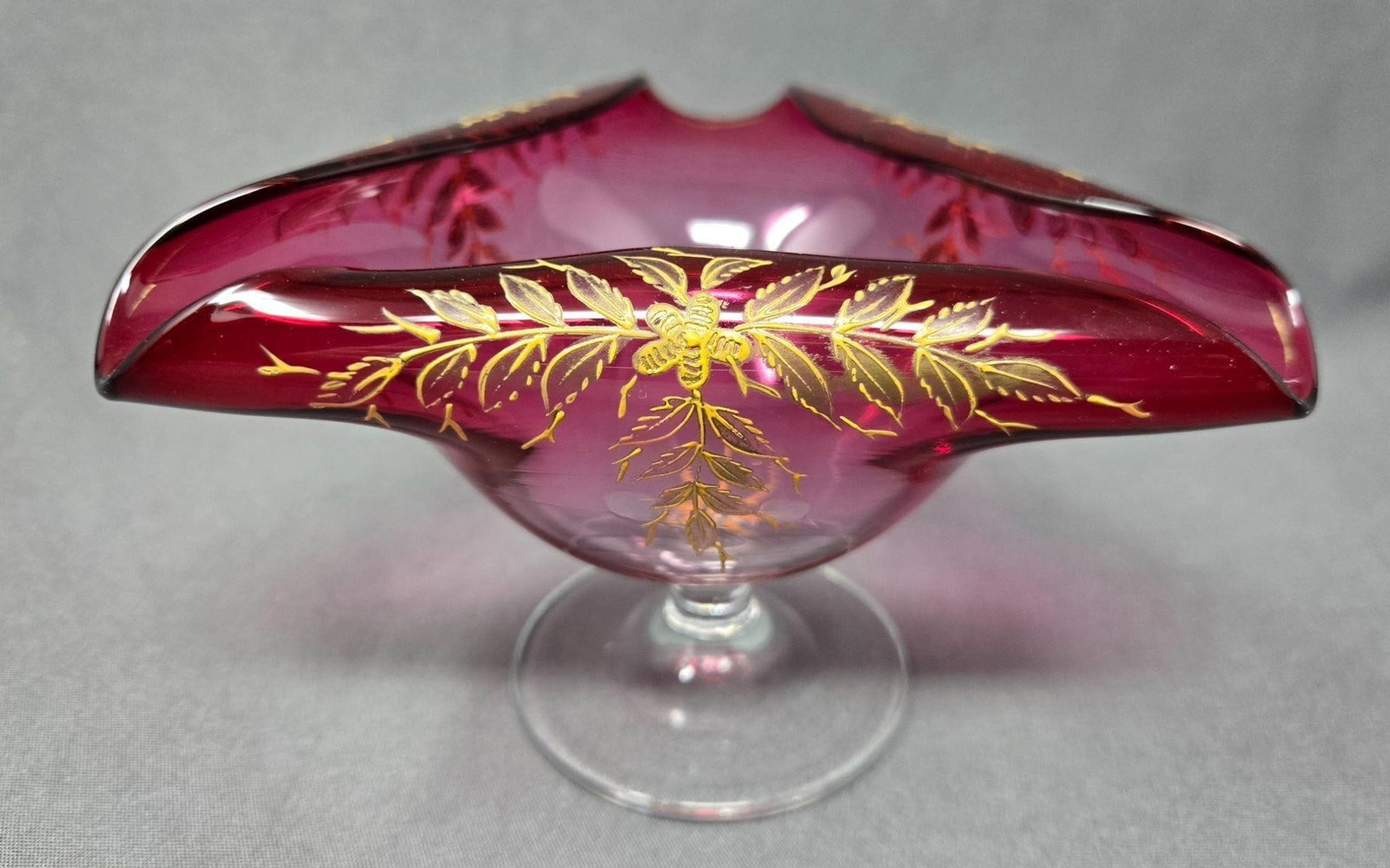 Bohemian Cranberry Glass Curled Lip Vase / Bowl: Bohemian hand enameled floral and leaves decorated vase / bowl. Hand blown cranberry glass on a clear foot. Measures 3 1/2 inches tall and 5 5/8 inches wide. Very good condition without chips or crack