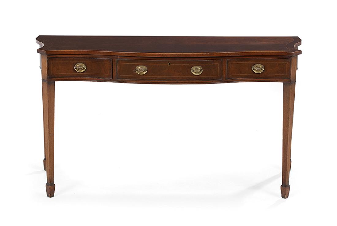 George III-Style Mahogany Serving Table: George III-Style Mahogany Serving Table, 19th century, the banded and shaped top above a conforming frieze fitted with three drawers, all banded and with string inlay, raised on tapering square legs e
