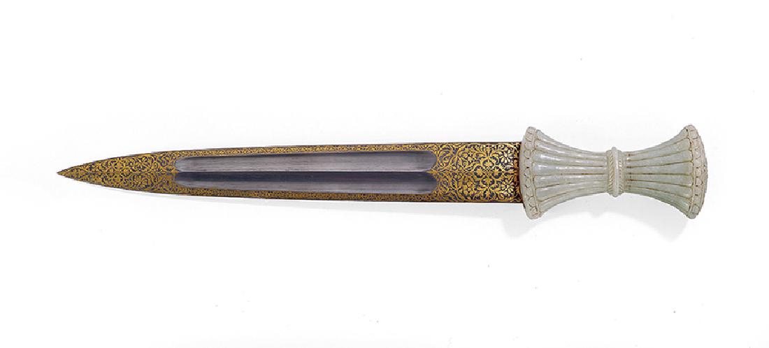 Mughal Jade and Gold-Damascened Wootz Dagger: Mughal Carved Jade and Gold-Damascened Wootz Dagger, ca. 1900, the reeded and waisted hilt topped with carved flowers, the wootz blade with gold damascene decoration surrounding the fuller on both sid