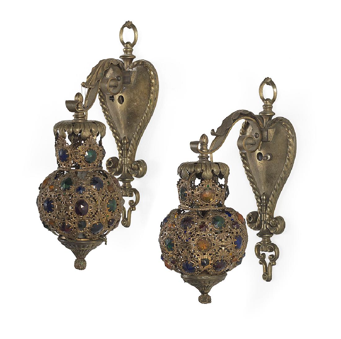 Pair of Jeweled Brass Sconces: Pair of Jeweled Brass Sconces in the Baronial Taste mid-20th century, Continental, with heart-shaped backplates, the pierced globe-form shades with inset faux jewels and suspended from scrolled arms. 