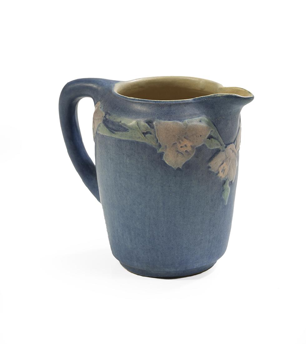Newcomb College Art Pottery Creamer: Newcomb College Art Pottery creamer, 1924 decorated by Sadie Irvine, the floral band with blue, pink and green underglaze over a matte blue ground, the base marked with Newcomb cipher, decorator's mar