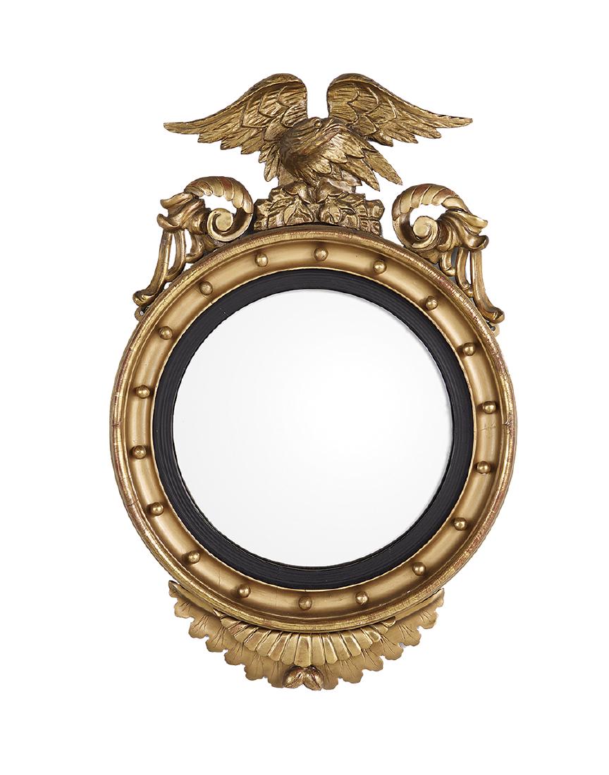 Regency Revival Giltwood Convex Mirror: Regency Revival Giltwood Convex Mirror ca. 1900, the convex mirror plate set into a reeded ebonized liner, the cove-molded frame set with gilt spherules and supporting a displayed eagle crest flanked 