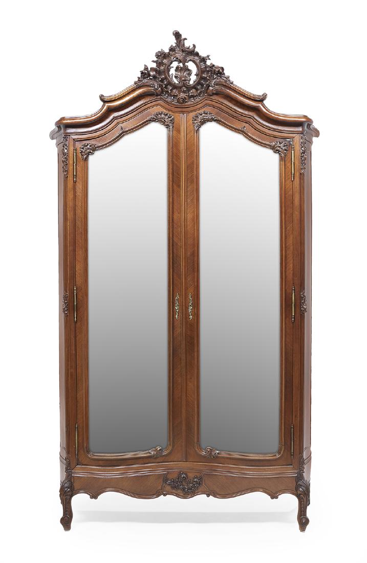 Louis XV-Style Kingwood Armoire: Louis XV-Style Kingwood Armoire late 19th century, the heavily molded and domed cornice centered by a large pierced foliate crest, above a case fitted with two long doors, each inset with a beveled mi