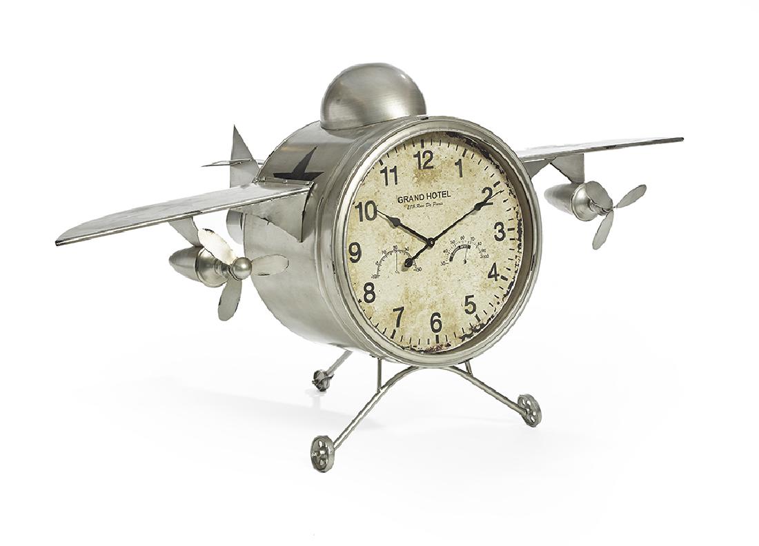Whimsical Painted Metal F-30 Model Airplane Clock: Whimsical Painted Metal F-30 Model Airplane Clock contemporary, the face labeled "Grand Hotel 285, Rue De Paris", mounted on wheels, the clock battery operated. h. 40", w. 77", d. 43"