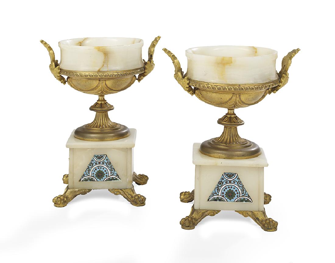 Pair of Alabaster and Enamel Garniture Urns: Pair of Alabaster, Gilt-Bronze and Champleve Enamel Garniture Urns first quarter 20th century, French, on paw feet, the alabaster urns set with gilt-bronze fittings and panels of champleve enamel. h.