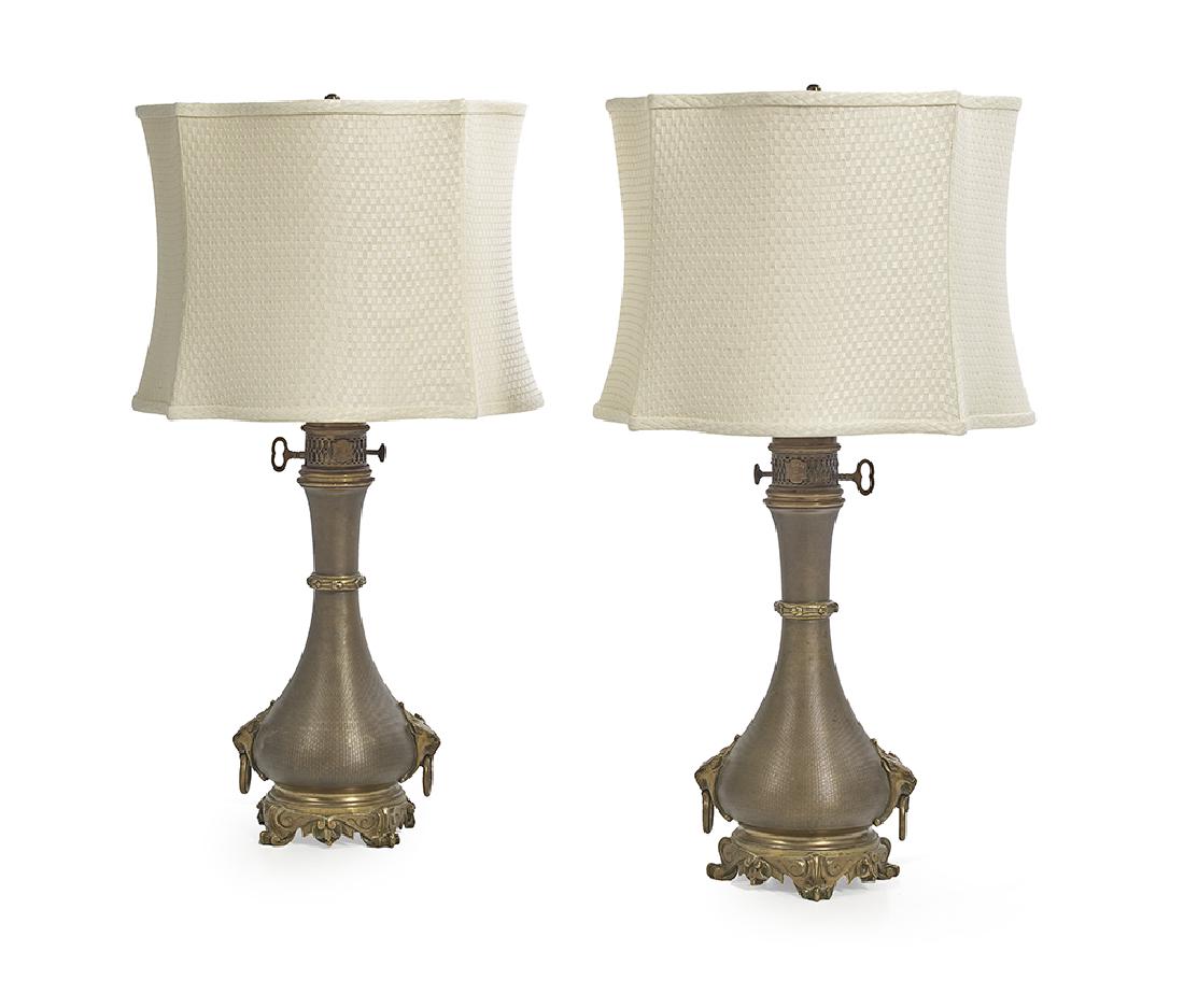 Pair of French Neo-Grec Moderator Lamps: Pair of French Neo-Grec Brass and Bronze Moderator Lamps fourth quarter 19th century, now mounted as electric lamps, the vasiform bases on brass scroll-molded feet, set with lion's-head ring pulls, on