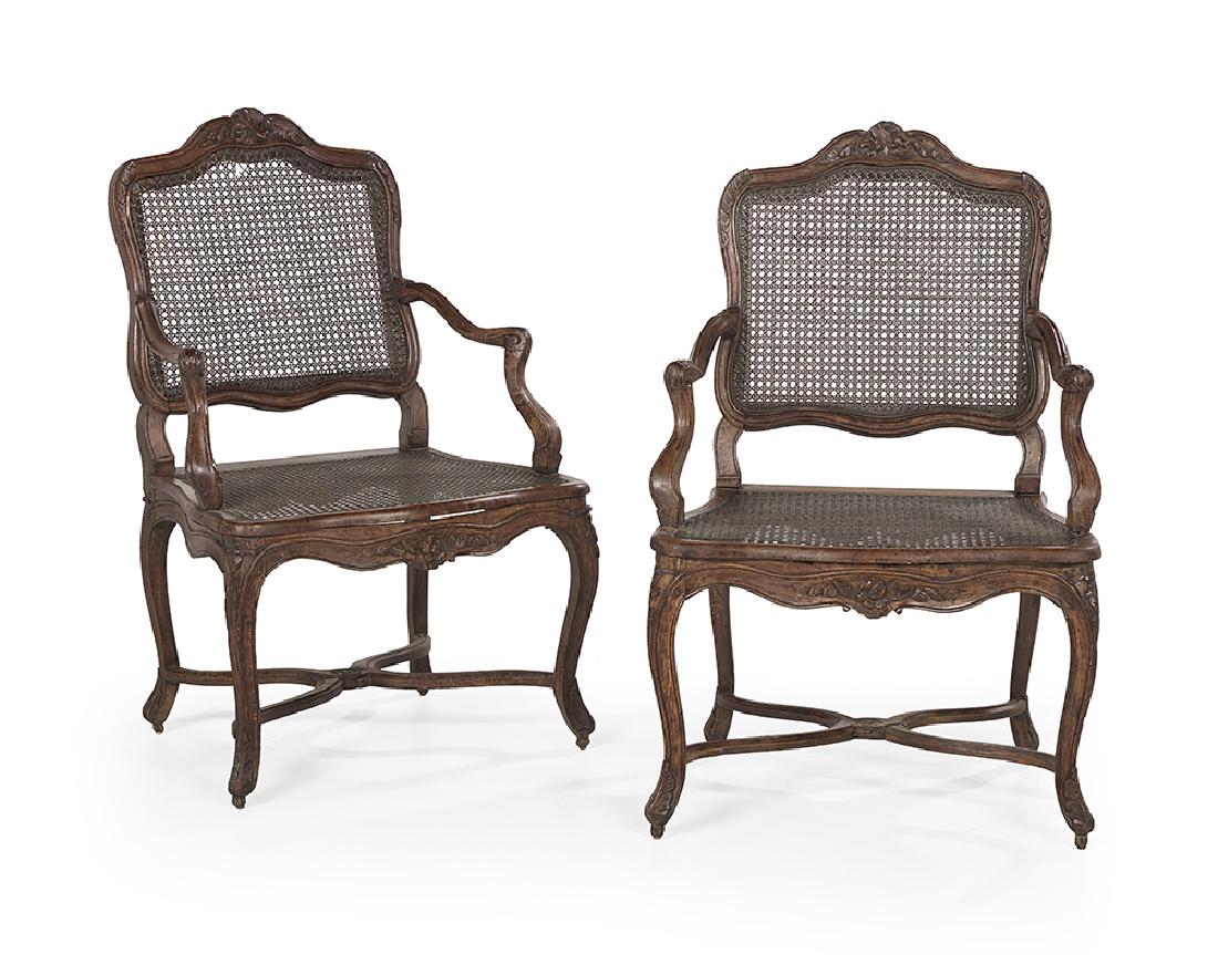 Pair of Provincial Louis XV-Style Fauteuils: Pair of Provincial Louis XV-Style Fauteuils late 18th century, each with a shaped caned back surmounted by a foliate crest, joined by shaped arms to the caned seat, raised on molded cabriole legs join