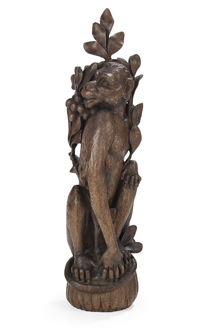 Well-Carved Oak Figure of a Monkey: Well-Carved Oak Figure of a Monkey fourth quarter 19th century, possibly Venetian Fantasy, the animal carved with a bow of branches and hanging fruit framing his face, on a feather-carved base. h. 29"