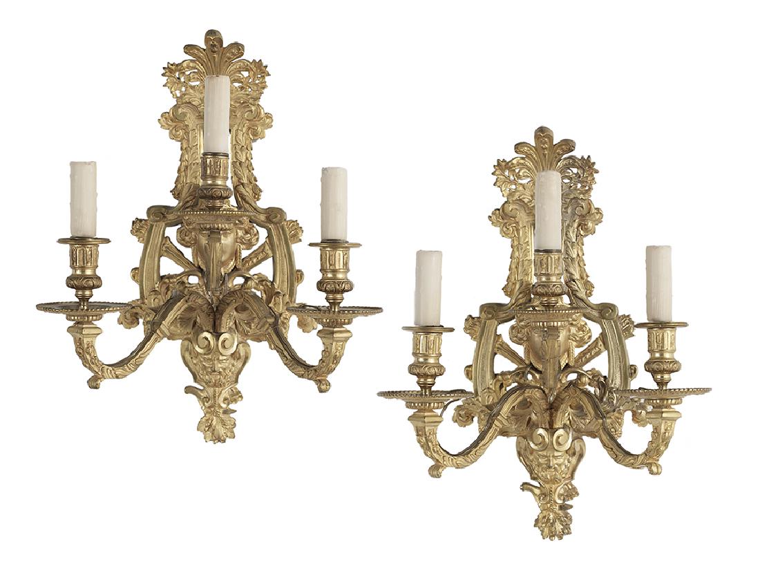 Pair of Louis XIV-Style Gilt-Bronze Sconces: Pair of Impressive Louis XIV-Style Gilt-Bronze Three-Light Sconces fourth quarter 19th century, with anthemion finials over pierced torchere backplates decorated with male and female masques, flanked 