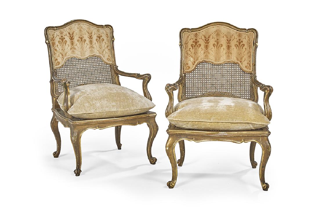 Pair of Louis XV-Style Giltwood Fauteuils: Pair of Louis XV-Style Giltwood Fauteuils late 19th century, each with a shaped caned back within a molded frame and with a partial fabric overlay, joined by outscrolled arms to the caned seat, raised