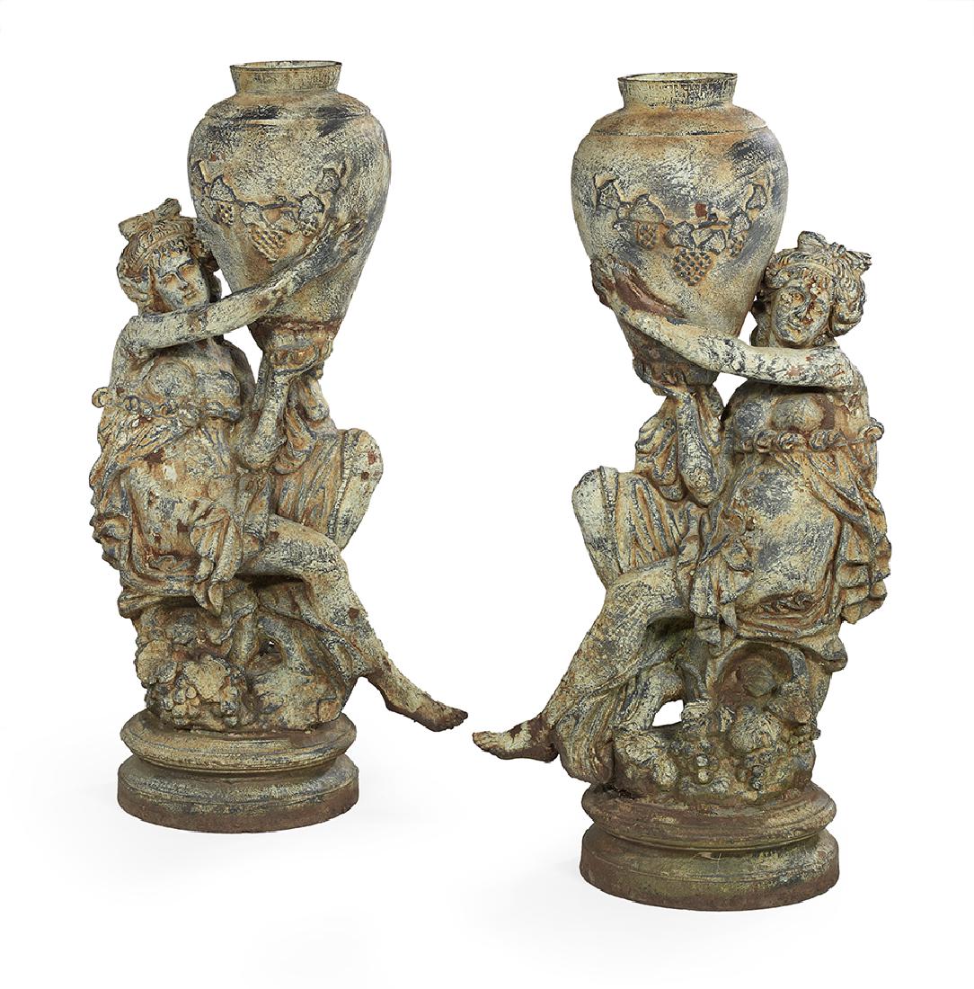 Pair of Cast Iron Figural Urns: Pair of Cast Iron Figural Urns 20th century, molded with water carriers, each seated nymph supporting an amphora decorated with molded grapes. h. 43", w. 22", d. 12"