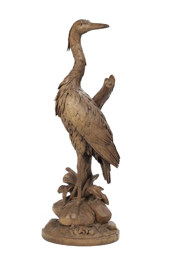 Black Forest-Style Carved Hardwood Egret: Black Forest-Style Carved Hardwood Egret fourth quarter 19th century, possibly Swiss, the masterfully carved bird standing on rocks with carved vegetation, above a mound of ivy and grass, one rock sig