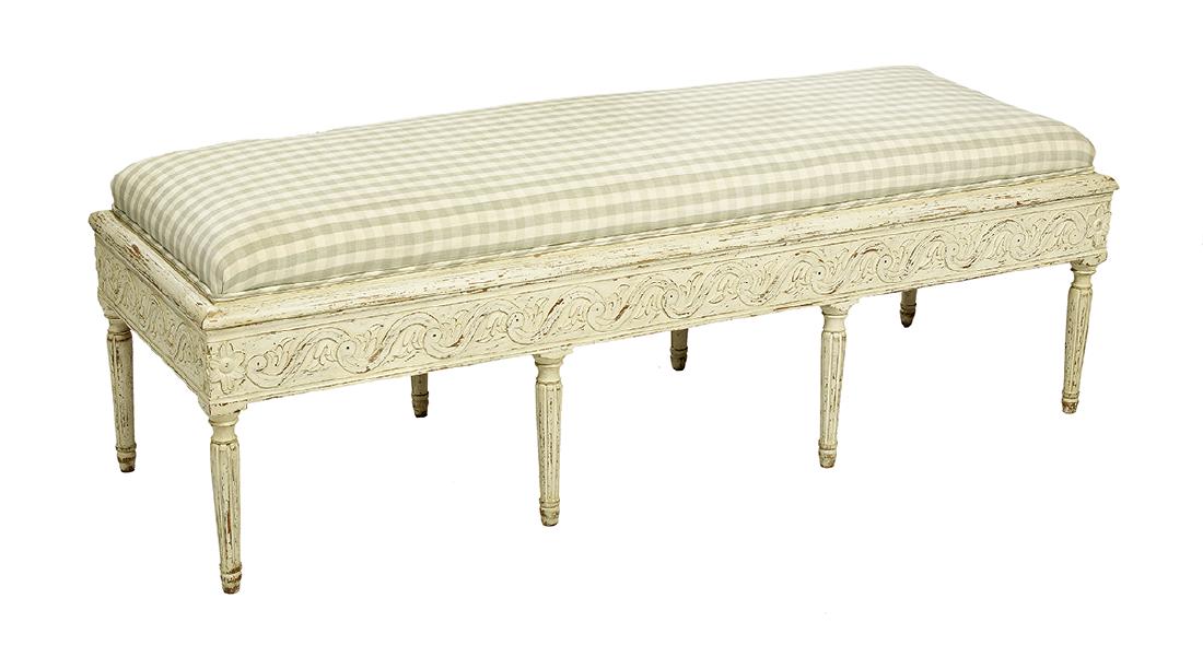 Louis XVI-Style Creme-Peinte Window Seat: Louis XVI-Style Creme-Peinte Window Seat the padded long rectangular top above a foliate- and wave-carved frieze, raised on fluted tapering circular legs ending in toupie feet. h. 19", w. 60-3/4", d. 