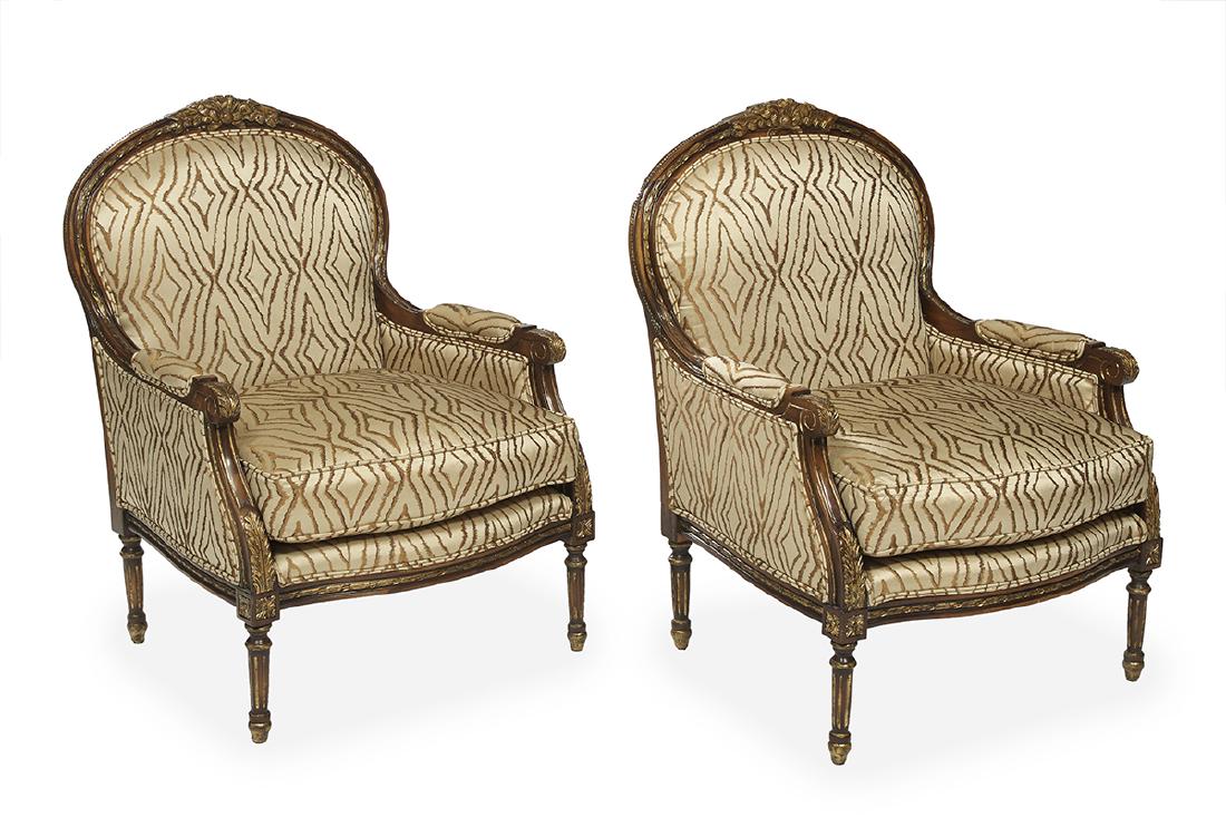 Pair of Louis XVI-Style Parcel-Gilt Bergeres: Pair of Louis XVI-Style Fruitwood and Parcel-Gilt Bergeres 20th century, each with a padded domed back surmounted by a gilt ribbon crest, joined by padded arms and sides to the cushioned seat, raised 