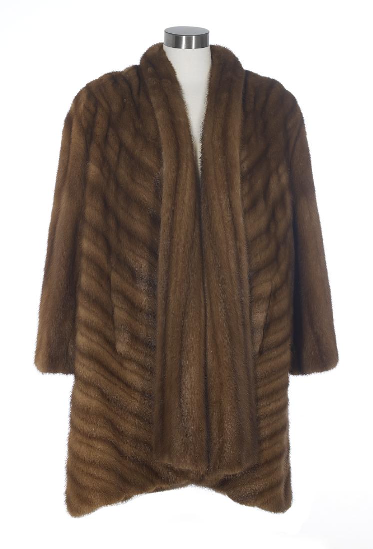 Vintage Mink Swing Coat: Vintage Mink Swing Coat 1980s, size 8-10, with tapered hem, shawl collar, padded shoulders, side pockets, bias pelts and straight sleeves, the chocolate silk-lined interior with a forward glove pocket