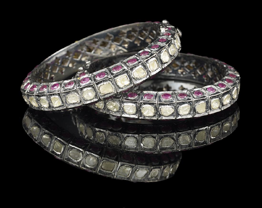 Two Ruby and Diamond Bangle Bracelets: Two Ruby and Diamond Bangle Bracelets sterling silver, the tops of the bracelets mounted with slice-cut diamonds weighing approximately 12.88 carats in total, and the sides mounted with oval-cut treat