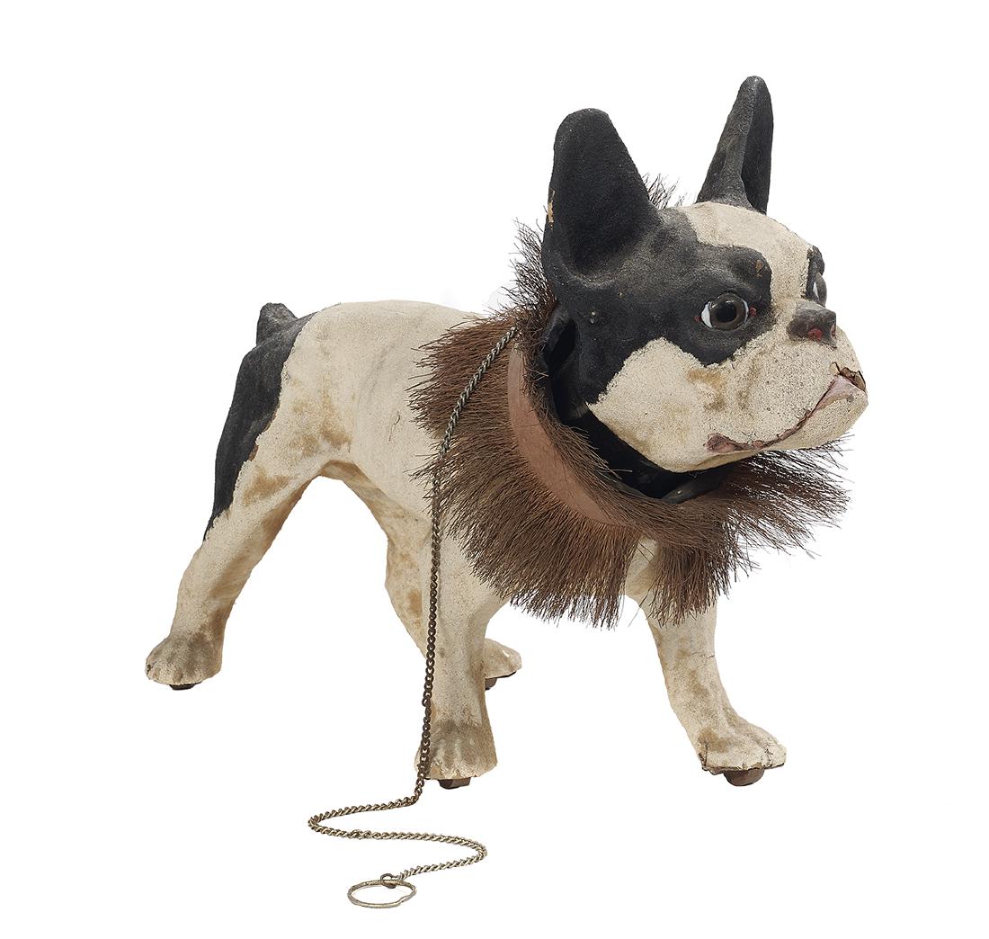French Papier-Mache "Growler" Pull Toy: French Papier-Mache "Growler" Pull Toy first quarter 20th century, the French bulldog with a coconut husk collar around his neck, his feet set on casters, the chain attached at the collar allowing his