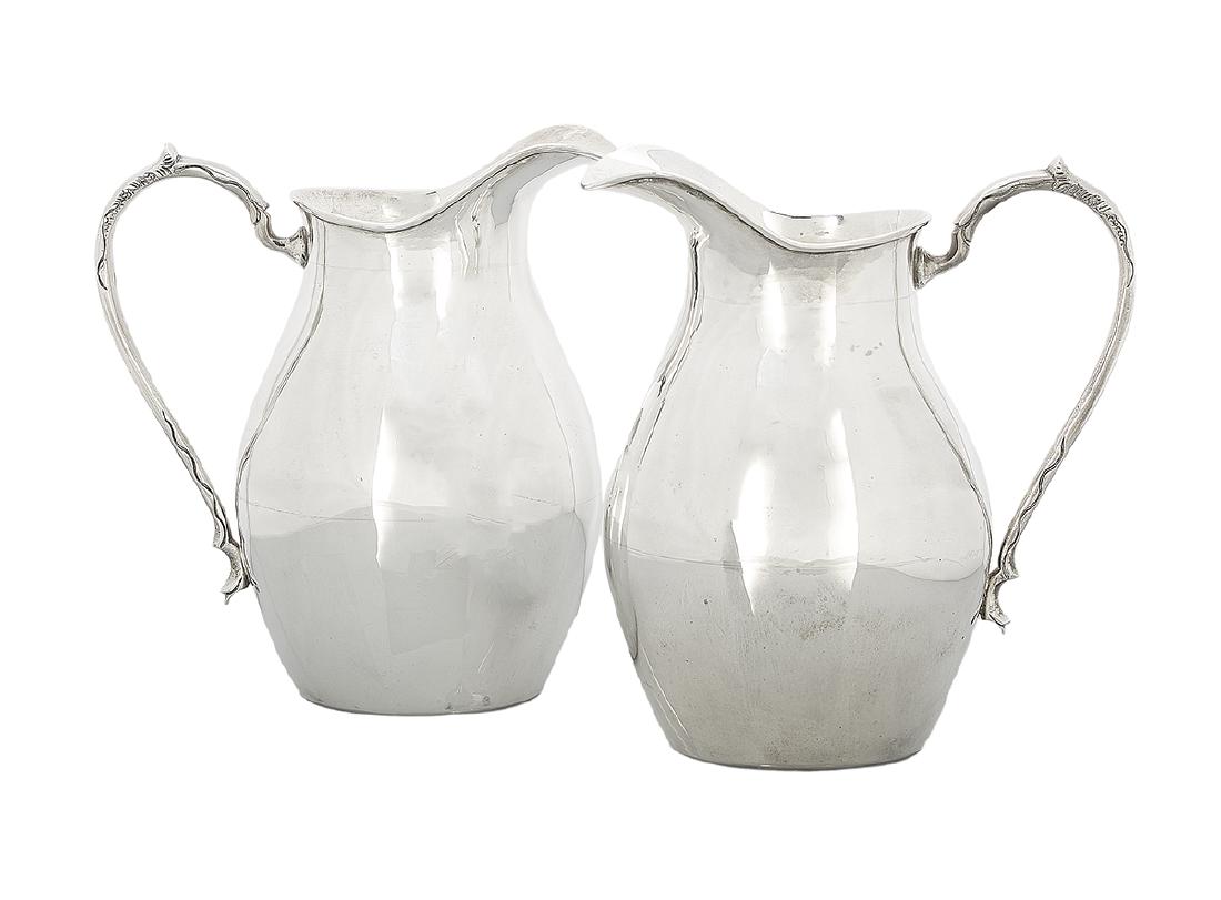 Cased Pair of South American Silver Pitchers: Cased Pair of South American Silver Pitchers mid-20th century, marked "Cespedes", Chile, .900 silver, each of ovoid form with integral spout and crested handle, presented in a cream satin-lined navy b