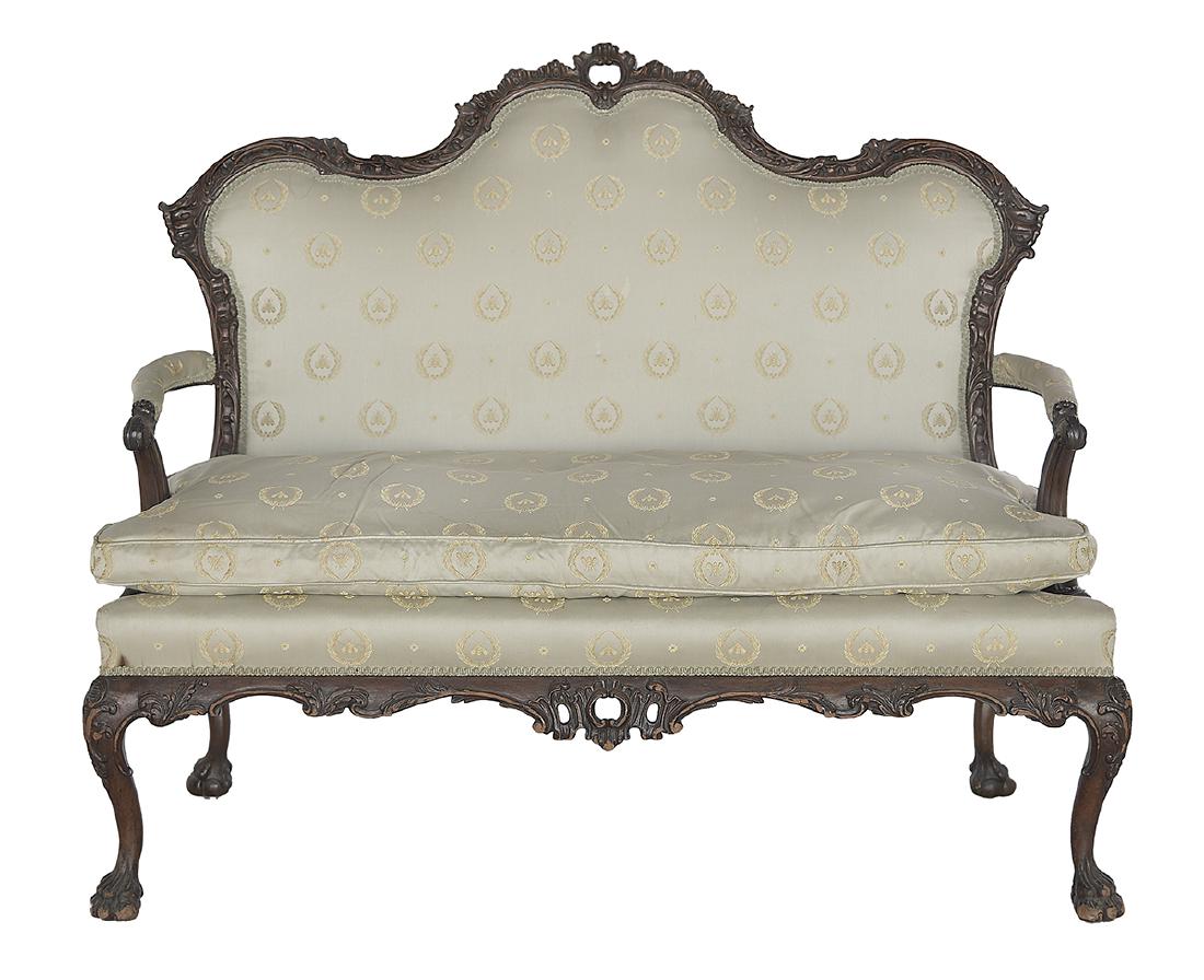 George III-Style Mahogany Settee: George III-Style Mahogany Settee 19th century, in the Chippendale rococo taste, the padded shaped and domed back within a foliate-carved frame, joined by padded arms to the cushioned seat, raised abov
