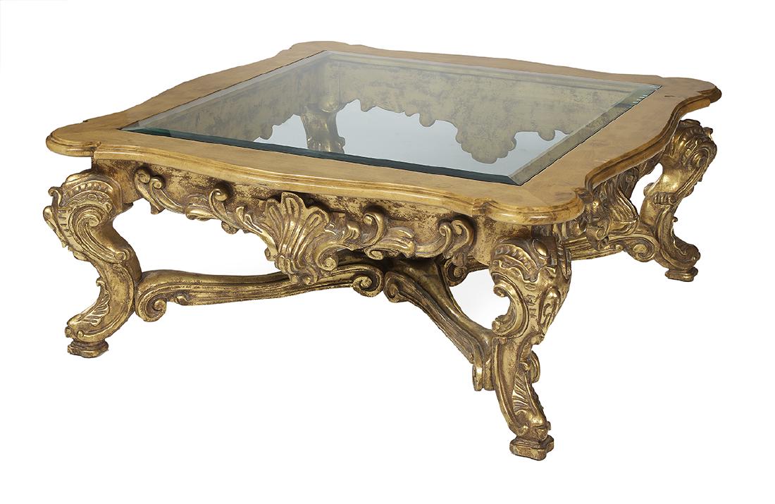 Baroque-Style Giltwood and Maple Cocktail Table: Baroque-Style Giltwood and Maple Cocktail Table the inset beveled glass top in a serpentine frame, raised on cabriole legs joined by shaped stretchers. h. 20-1/2", w. 46-1/2", d. 46-1/2"