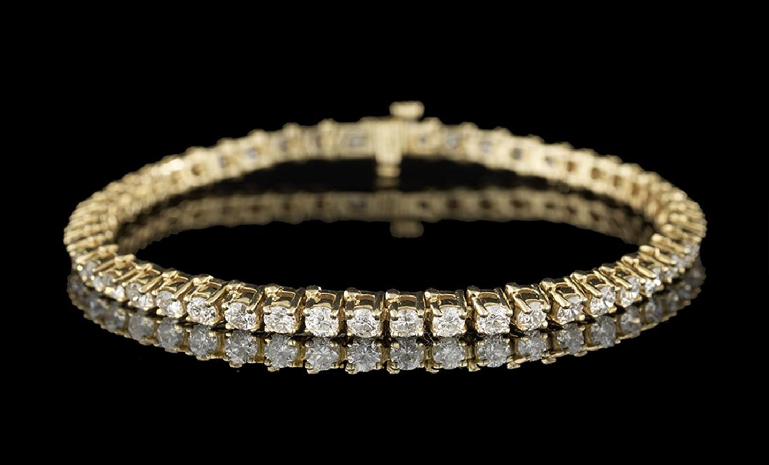 Diamond Tennis Bracelet: Diamond Tennis Bracelet 14k yellow gold, the bracelet composed of round brilliant-cut diamonds weighing approximately 5.14 carats in total, approximate color E-G and clarity SI1-I1. l. 7-1/4", total w